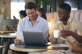 Two Businessmen Working On Laptop In Informal Seating Area Of Modern Office On Coffee Break Royalty Free Stock Photo