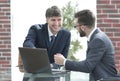 Two businessmen working together using laptop on business meeting in office Royalty Free Stock Photo