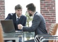 Two businessmen working together using laptop on business meeting in office Royalty Free Stock Photo