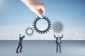 Two businesspartners holding gears and cogs system Royalty Free Stock Photo