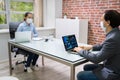 Two Businesspeople Analyzing Financial Graph On Laptop