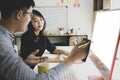 Two businesspeople discussing and analyzing data on computer together in the office. Royalty Free Stock Photo