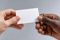 Two businesspeople exchanging business card on gray background Royalty Free Stock Photo