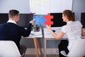 Two Businesspeople Joining Jigsaw Pieces Royalty Free Stock Photo