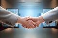 Two businesspeople\'s hands wearing suits shaking hands on the background of the office in a large company