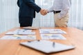 Two businesspeople shake hand after signing contract document. Entity Royalty Free Stock Photo