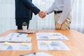 Two businesspeople shake hand after signing contract document. Entity Royalty Free Stock Photo