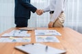 Two businesspeople shake hand after signing contract document. Entity Royalty Free Stock Photo