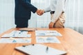 Two businesspeople shake hand after signing contract document. Entity Royalty Free Stock Photo