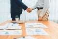 Two businesspeople shake hand after signing contract document. Entity Royalty Free Stock Photo