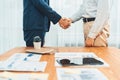 Two businesspeople shake hand after signing contract document. Entity Royalty Free Stock Photo