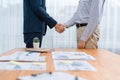 Two businesspeople shake hand after signing contract document. Entity Royalty Free Stock Photo