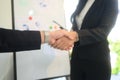 Two businesspeople shaking hands after successful negotiation in the modern office Royalty Free Stock Photo