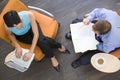 Two businesspeople sitting indoors having meeting