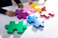 Two Businesspeople Solving Jigsaw Puzzle Royalty Free Stock Photo