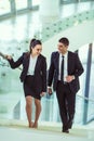 Two businesspeople talking as they walk into the office Royalty Free Stock Photo