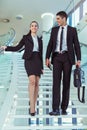 Two businesspeople talking as they walk into the office Royalty Free Stock Photo