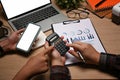 Two businesspeople using calculator and analyzing financial document at office. Royalty Free Stock Photo