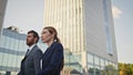 Two businesspeople walking urban district in elegant formal suits close up. Royalty Free Stock Photo