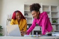 Two businesswoman African American working together using laptop and talking about a business project. team of females Royalty Free Stock Photo