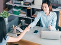 Two businesswoman handshake in causal meeting at home office desk about business planing,business teamwork,top view of asian Royalty Free Stock Photo