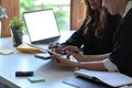 Two businesswoman reviewing financial documents together.