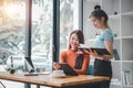 Two businesswoman working together on digital tablet. Royalty Free Stock Photo