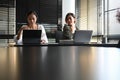 Two businesswomen are discussing business project and working together with computer tablet in office. Royalty Free Stock Photo