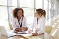 Two businesswomen discussing project, looking at each other Royalty Free Stock Photo