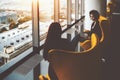 Two businesswomen having work meeting near office windows Royalty Free Stock Photo