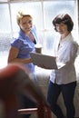 Two Businesswomen With Laptop Having Informal Meeting In Office Royalty Free Stock Photo