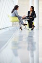 Two Businesswomen Meeting Around Table In Modern Office Royalty Free Stock Photo
