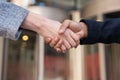 Two businesswomen in office suits shaking hands The concept of joyful business partners Royalty Free Stock Photo