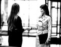 Two businesswomen shaking hands in the office lobby. Royalty Free Stock Photo