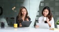 Two business women sitting in office and sharing ideas or startup business plan together. Royalty Free Stock Photo