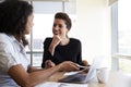 Two Businesswomen Using Laptop Computer In Office Meeting Royalty Free Stock Photo