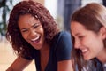 Two Businesswomen Working At Desk By Window In Office Collaborating On Project Together Royalty Free Stock Photo