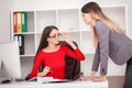 Two businesswomen working together.Girl is sitting at table in f Royalty Free Stock Photo