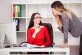 Two businesswomen working together.Girl is sitting at table in f Royalty Free Stock Photo