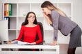 Two businesswomen working together.Girl is sitting at table in f Royalty Free Stock Photo