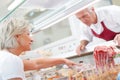 Two butcher checking their display neat