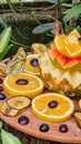 Two butterflies feeding on sliced fruit that includes oranges, grapes, pineapple, papaya and banana Royalty Free Stock Photo