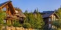 Two cabins in luxury neighborhood at sunset pano