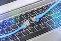 Two cables on computer keyboard symbolizing connection to cyberspace