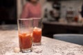 Two caesar glasses on a kitchen counter.