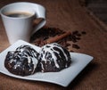 Two cakes on a white rectangular saucer glazed with black and white chocolate. Royalty Free Stock Photo