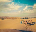 Two cameleers camel drivers with camels in dunes of Thar deser Royalty Free Stock Photo