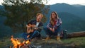 Two campers rest outdoors in mountains. Happy couple spend vacation closeup.