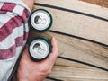 Two can of beer, female and male hands Royalty Free Stock Photo