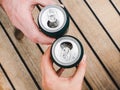 Two can of beer, female and male hands Royalty Free Stock Photo